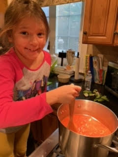 Helping make the sauce in the kitchen