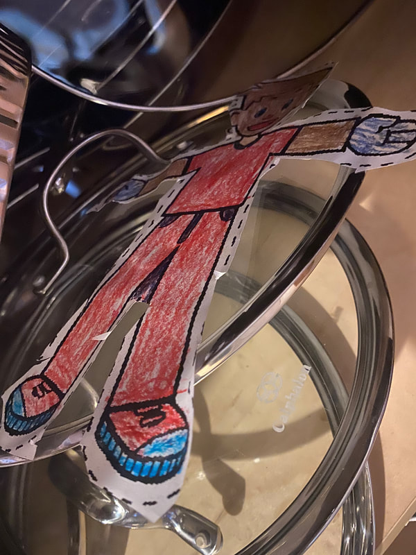 Flat Stanley hiding in the pots and pans