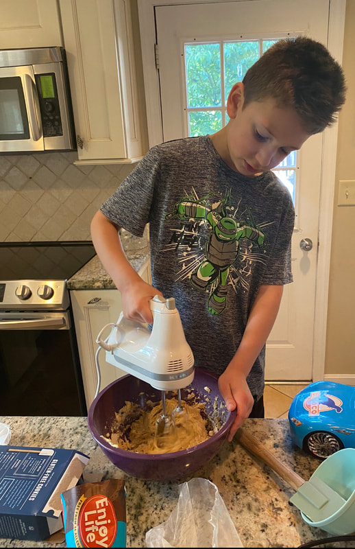 Helping mix the recipe in the kitchen