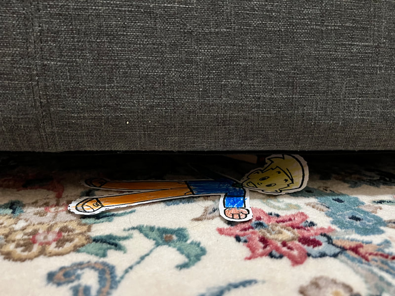 Flat Stanley hiding under the couch