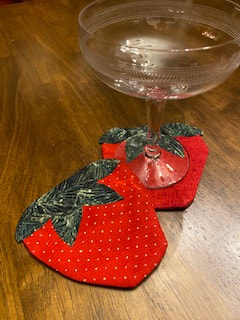 two sewn strawberry coasters