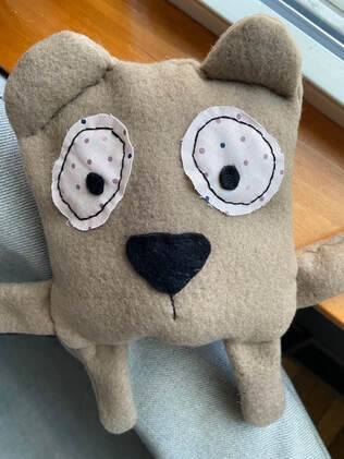 Brown sewn bear with large face